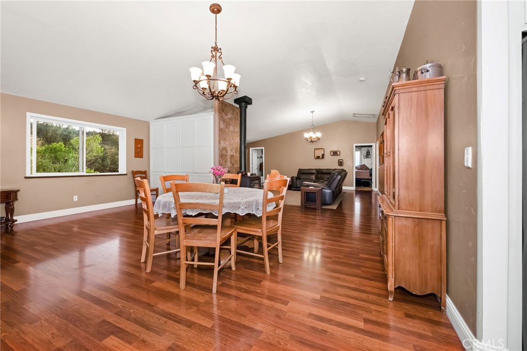 2728 Pentz Road Oroville, CA 95965 - Photo 10 of 52 a dining room with wooden floor a chandelier a wooden table and chairs
