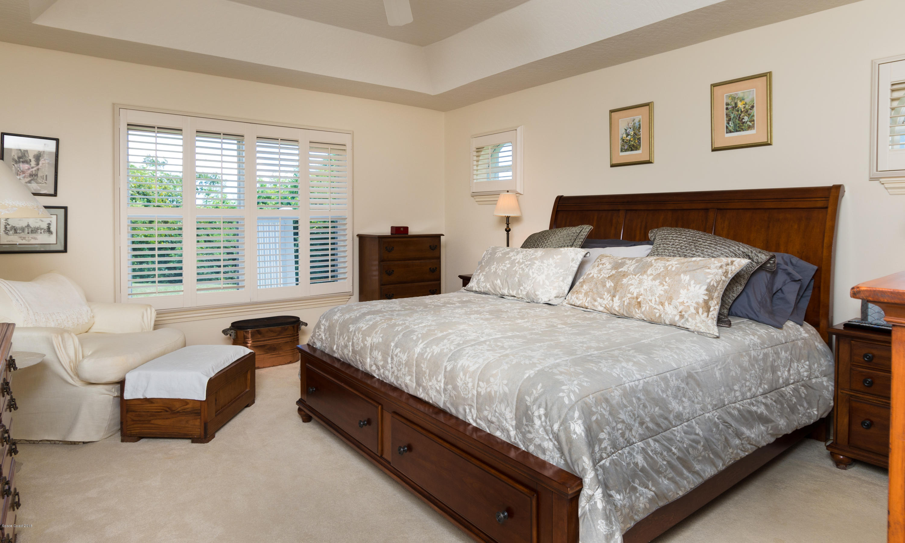 3535 Shady Run Road Melbourne, FL 32934 - Photo 12 of 30 a bedroom with a bed and a couch next to a window