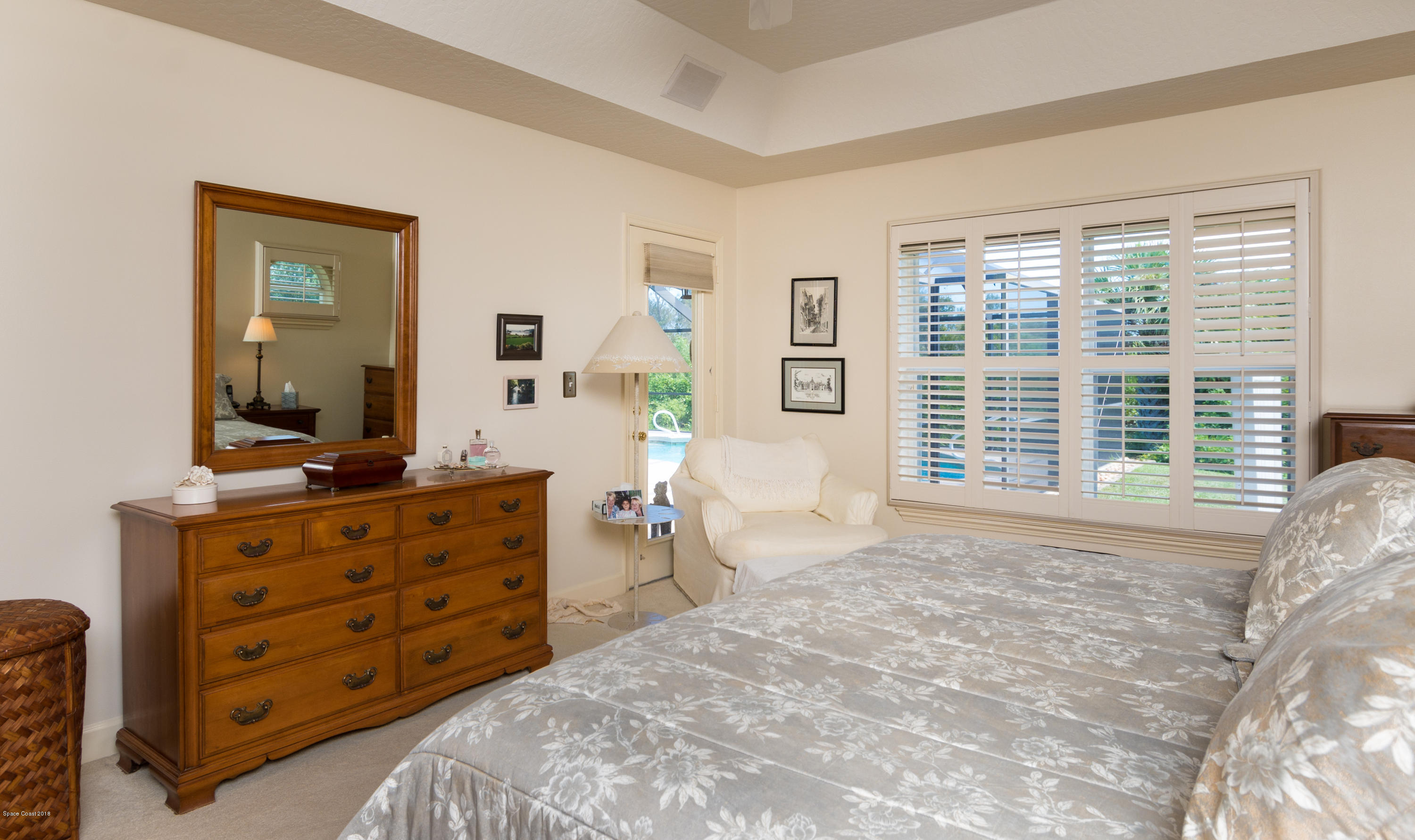 3535 Shady Run Road Melbourne, FL 32934 - Photo 13 of 30 a bedroom with a bed and a dresser in it
