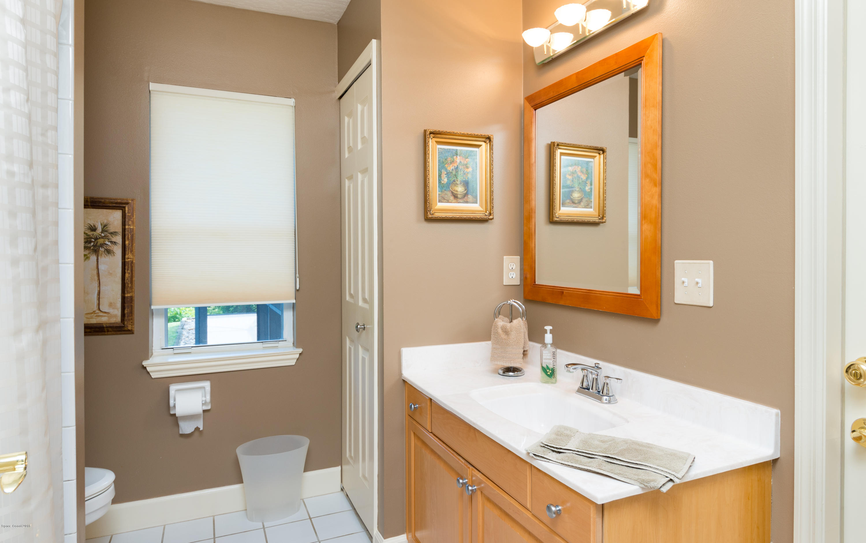 3535 Shady Run Road Melbourne, FL 32934 - Photo 18 of 30 a bathroom with a sink vanity and a toilet