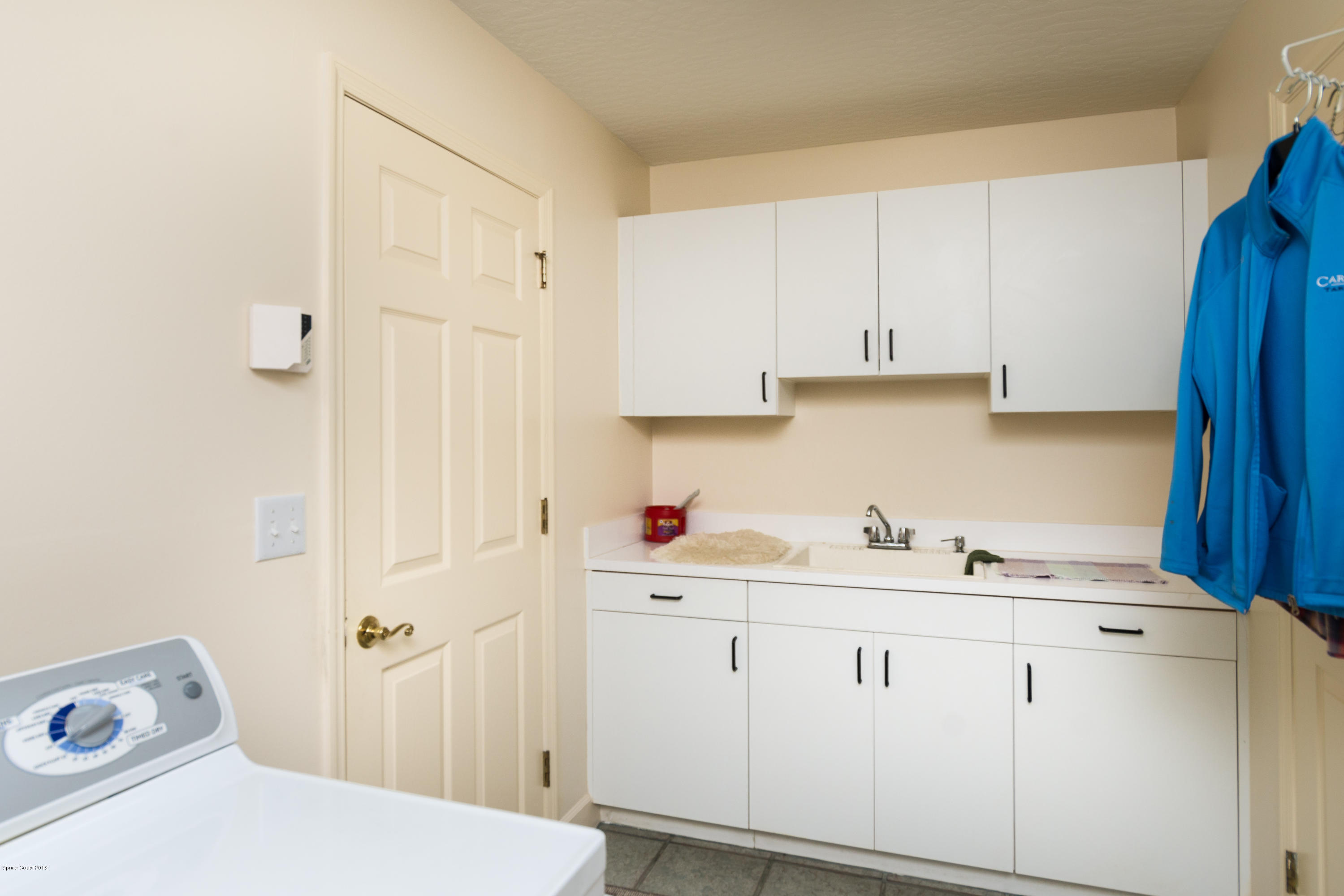 3535 Shady Run Road Melbourne, FL 32934 - Photo 19 of 30 a room with a sink cabinets and utility
