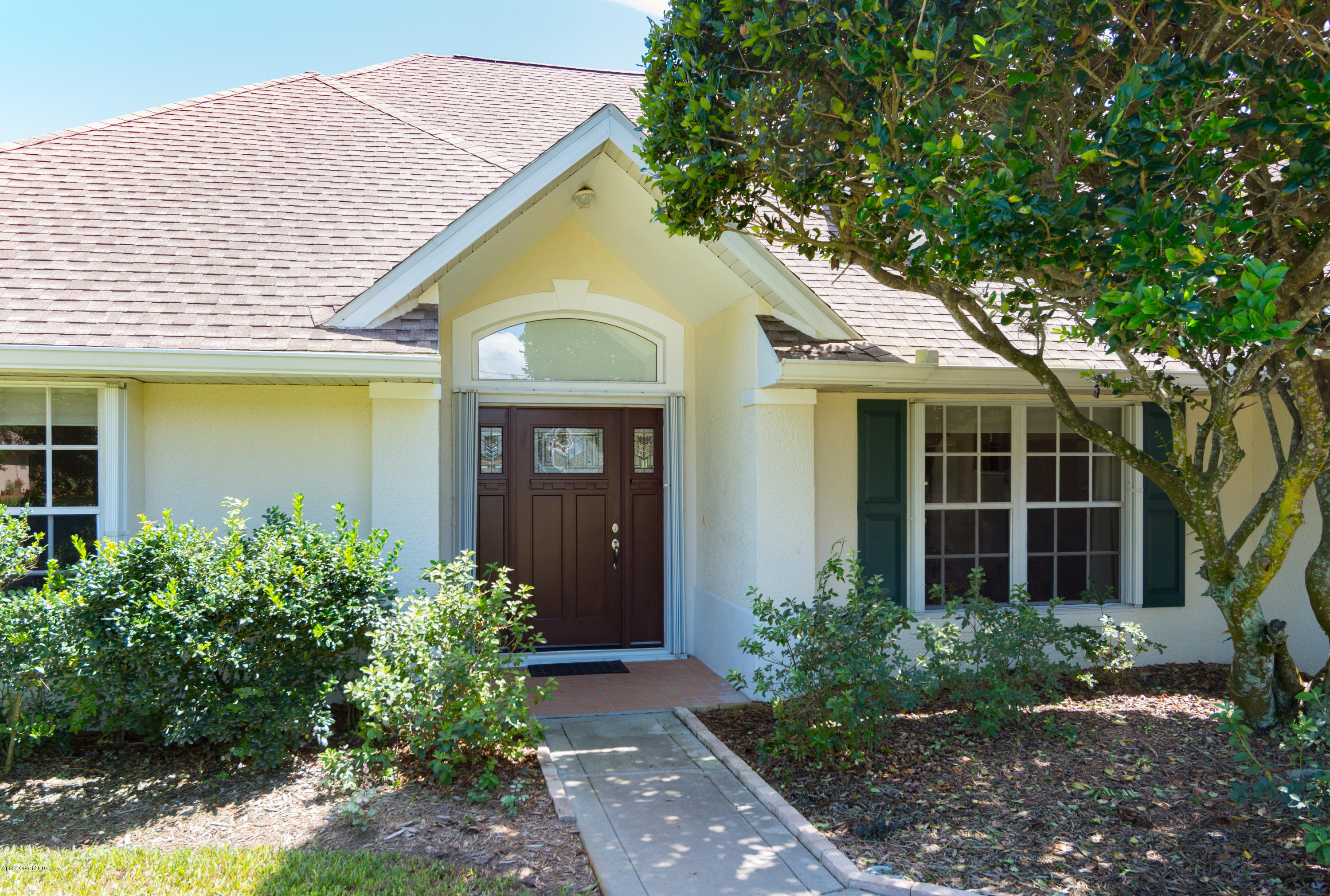 3535 Shady Run Road Melbourne, FL 32934 - Photo 3 of 30 a front view of a house with garden