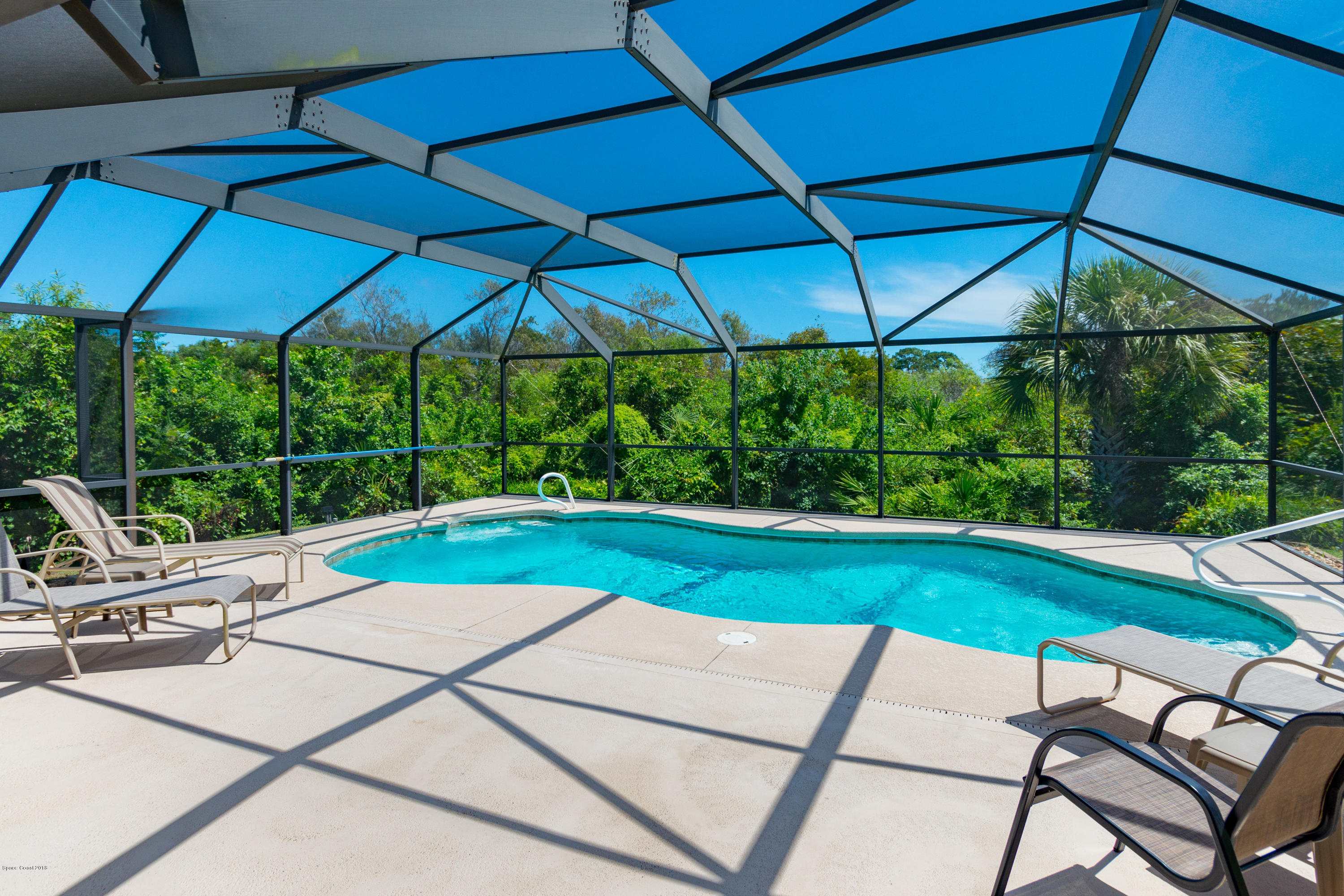 3535 Shady Run Road Melbourne, FL 32934 - Photo 21 of 30 a view of pool with lawn chairs under an umbrella