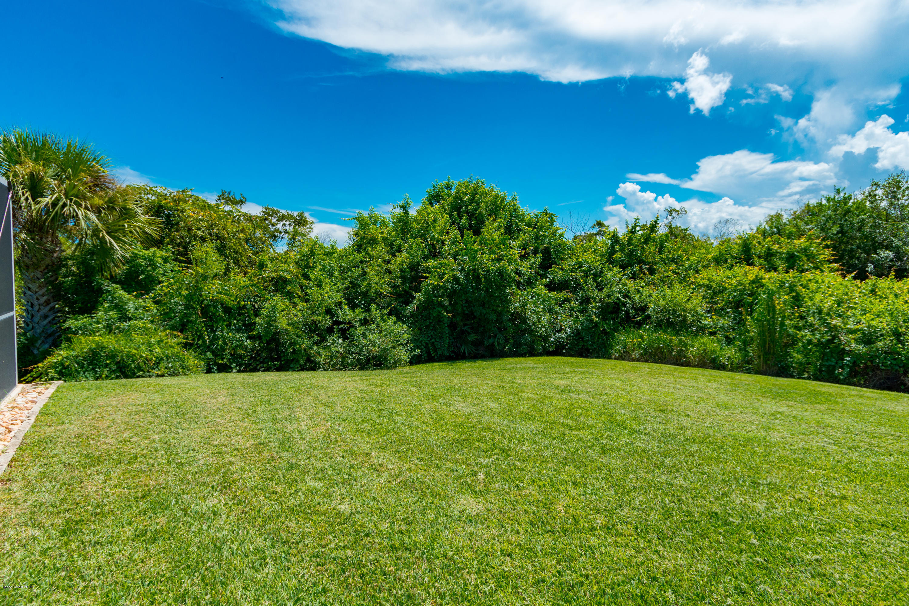 3535 Shady Run Road Melbourne, FL 32934 - Photo 22 of 30 a view of a grassy field with an trees