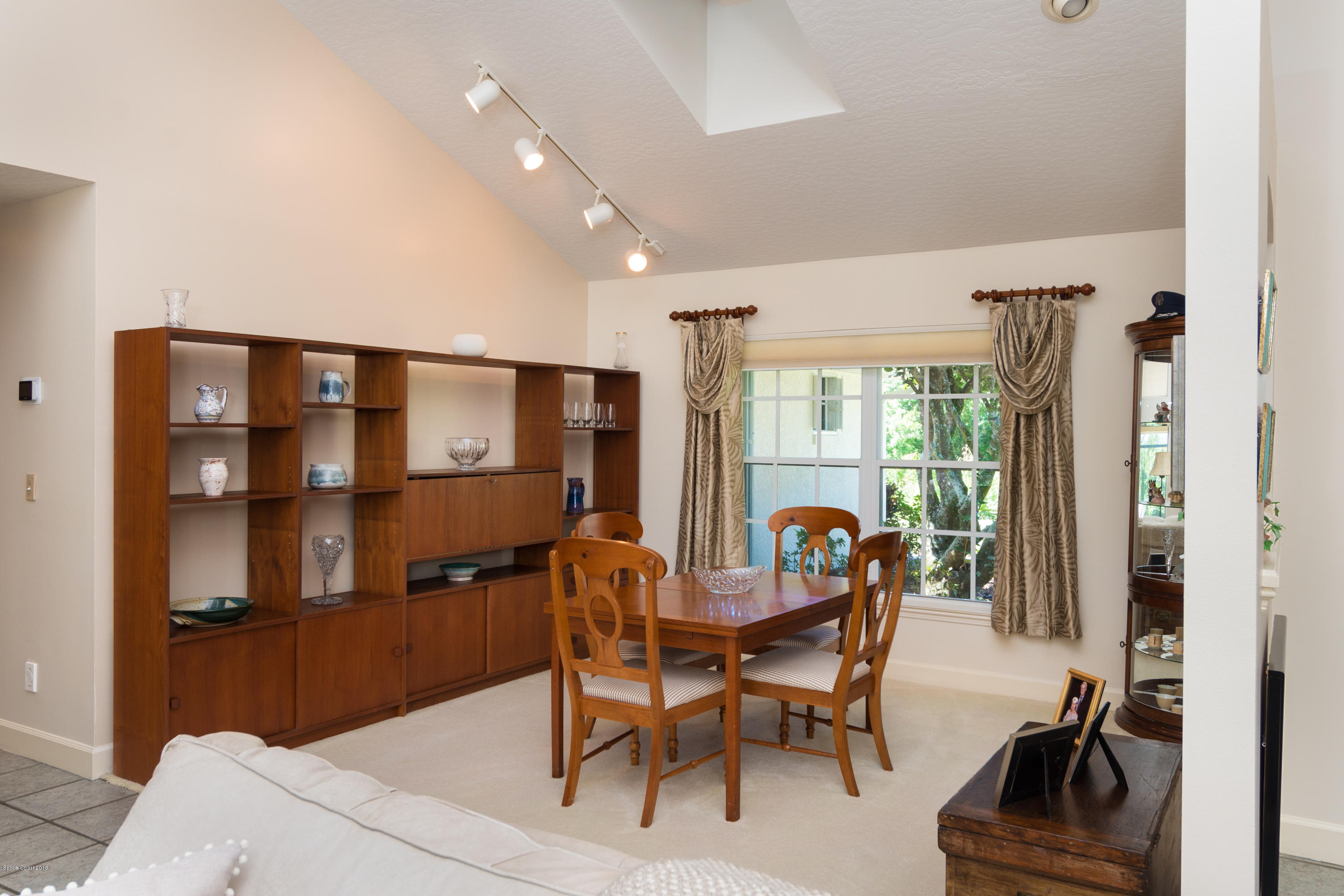 3535 Shady Run Road Melbourne, FL 32934 - Photo 7 of 30 a view of a dining room with furniture and a window