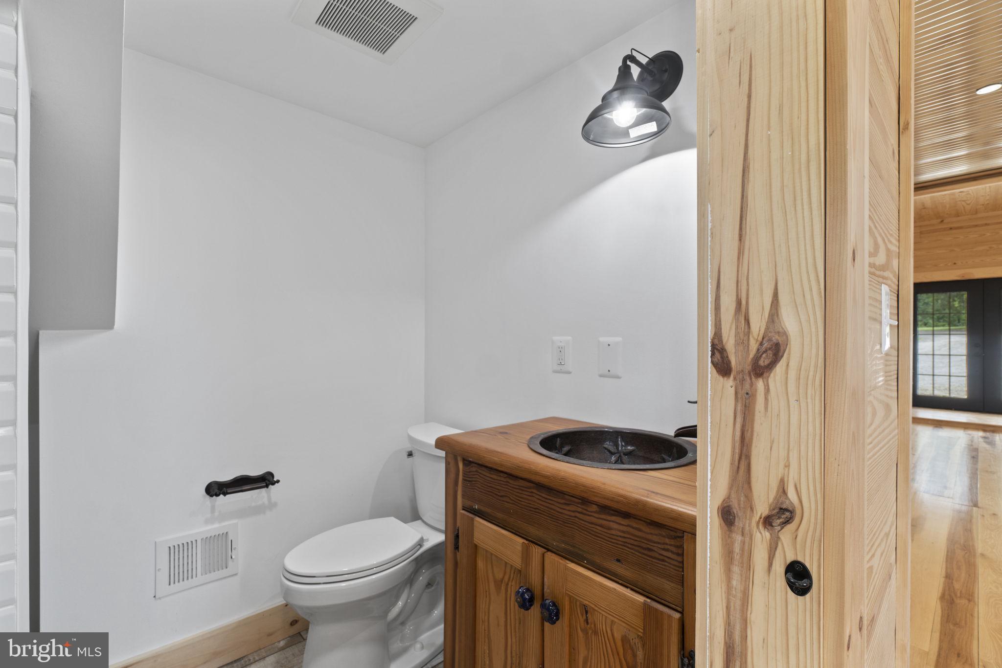 13316 Compton Road Clifton, VA 20124 - Photo 12 of 39 a bathroom with a granite countertop toilet and a sink