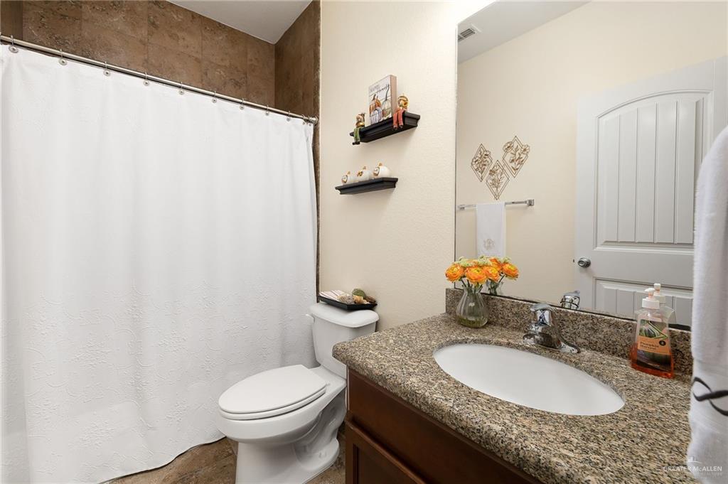 3901 Santa Veronica Street Mission, TX 78572 - Photo 15 of 22 a bathroom with a granite countertop sink and a mirror