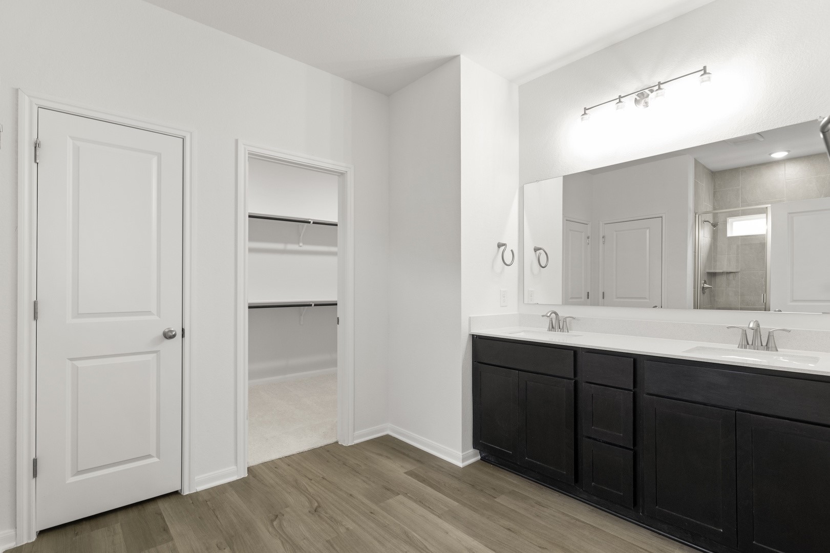 3725 Pin Oak Hills Seguin, TX 78155 - Photo 13 of 21 Full bathroom with double vanity, a stall shower, light wood-type flooring, and a spacious closet
