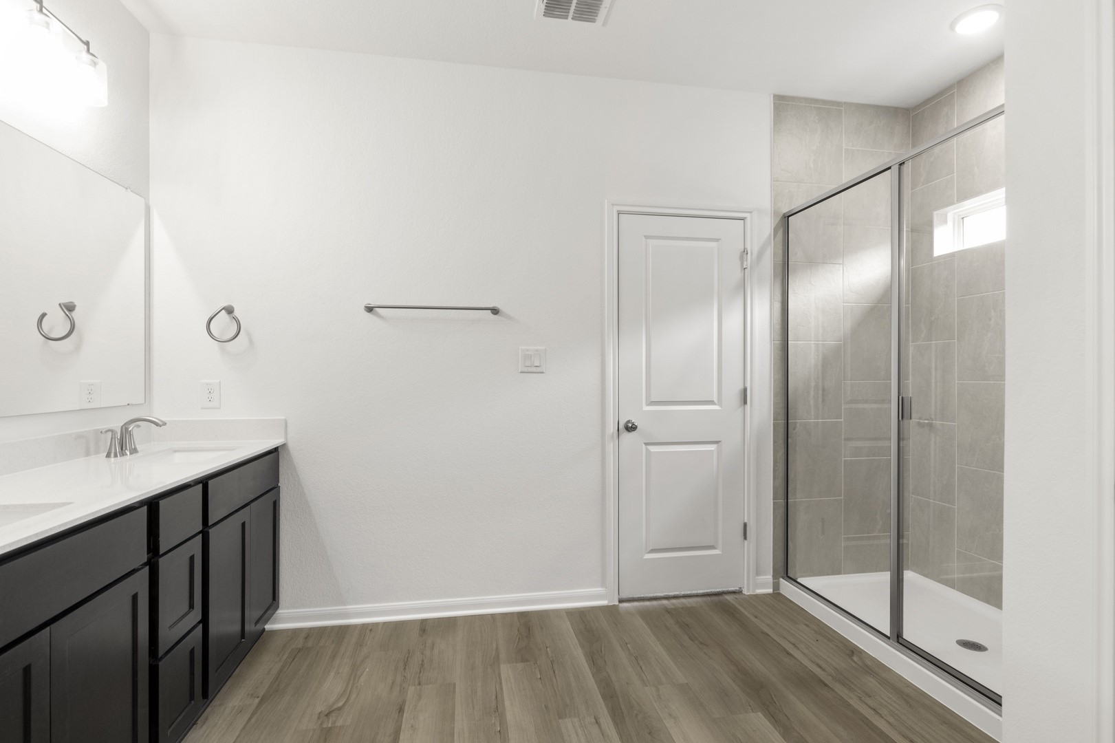 3725 Pin Oak Hills Seguin, TX 78155 - Photo 14 of 21 Bathroom featuring a stall shower, double vanity, and light wood-style floors