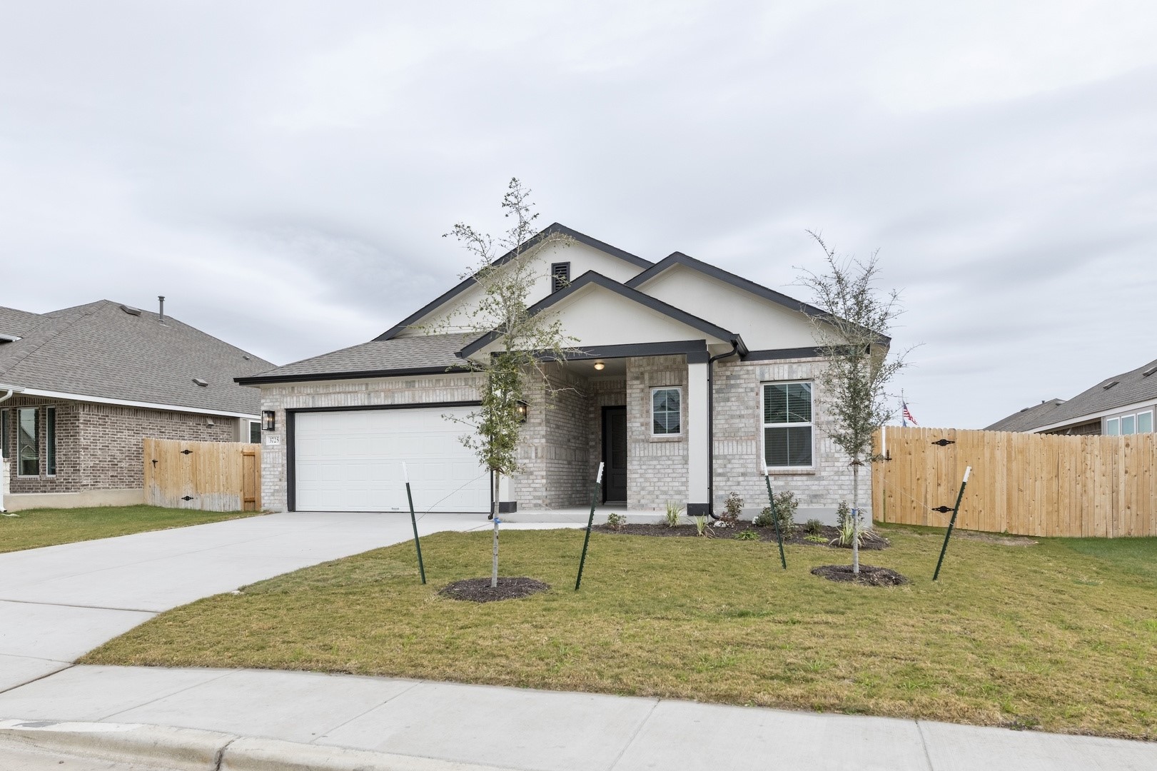 3725 Pin Oak Hills Seguin, TX 78155 - Photo 3 of 21 View of front of property featuring brick siding, a gate, driveway, and a garage