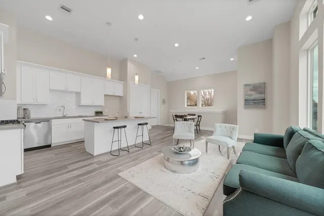 a living room with kitchen island furniture and a kitchen view