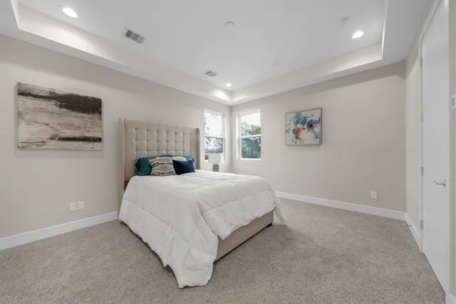 a bedroom with a bed and wall painting