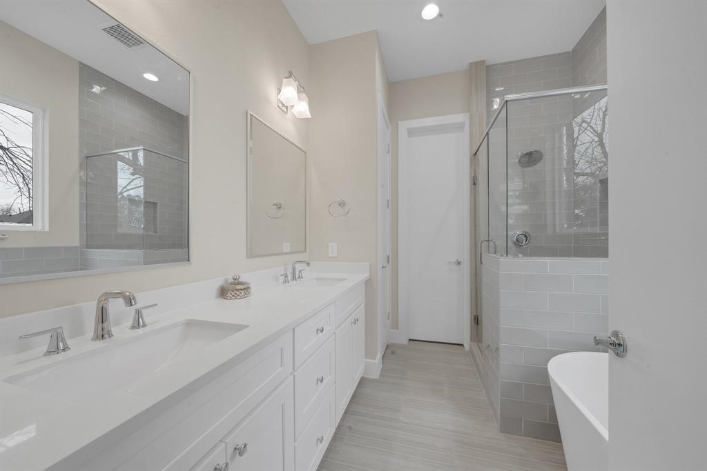 5904 Gardendale Drive, Unit D Houston, TX 77092 - Photo 6 of 7 a spacious bathroom with a double vanity sink mirror and shower