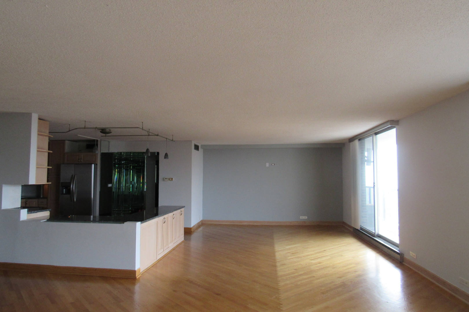 5855 North Sheridan Road, Unit 14CE Chicago, IL 60660 - Photo 6 of 14 an empty room with wooden floor and windows