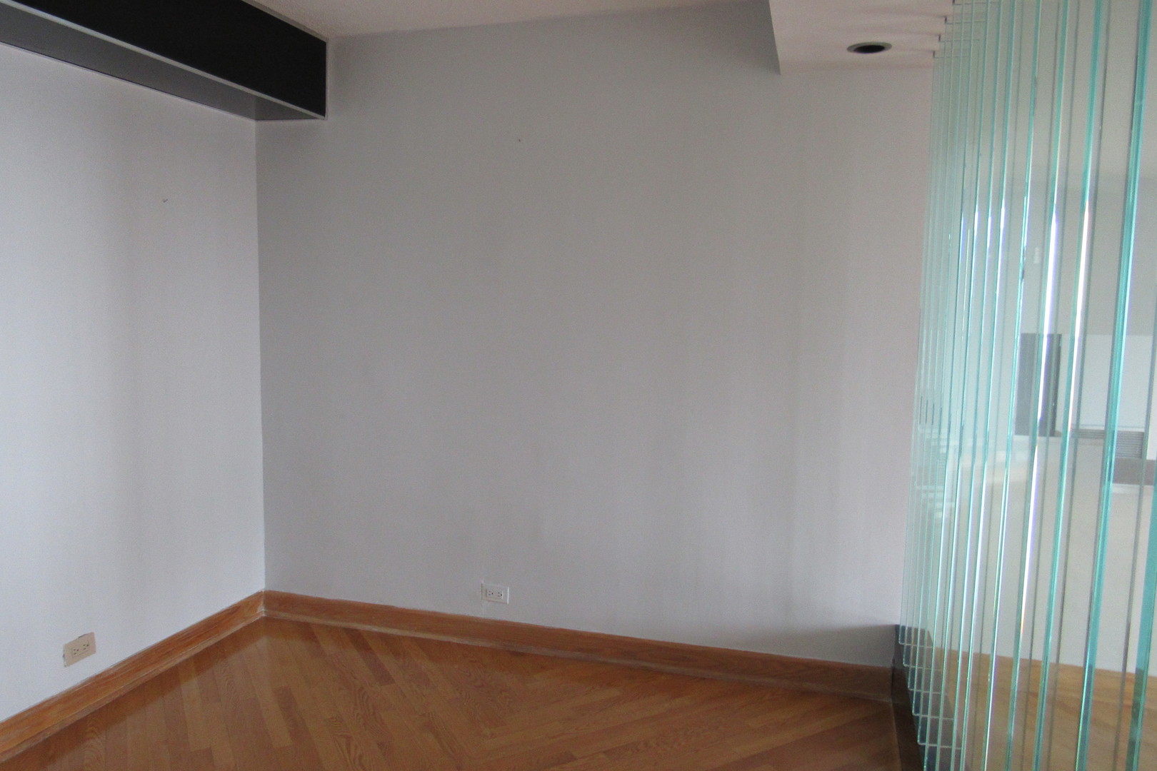 5855 North Sheridan Road, Unit 14CE Chicago, IL 60660 - Photo 9 of 14 a view of a small space with wooden floor and a window