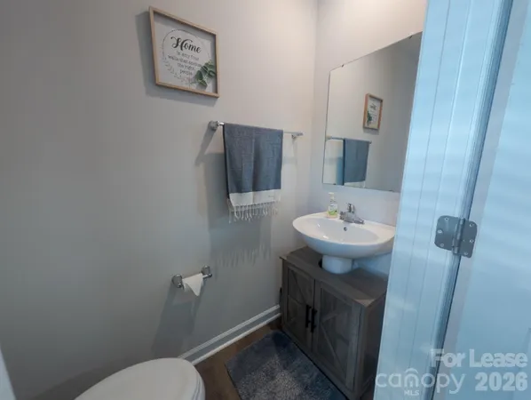 a bathroom with a sink toilet and mirror