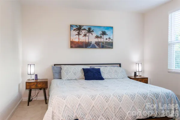 a bedroom with a bed and a night stand