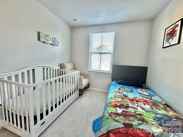 a bedroom with bed and a window