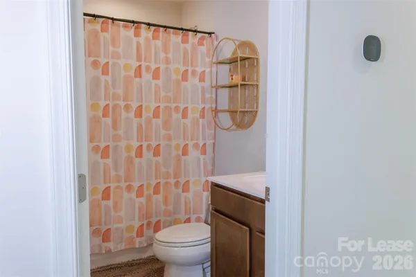 a white toilet sitting next to a shower curtain