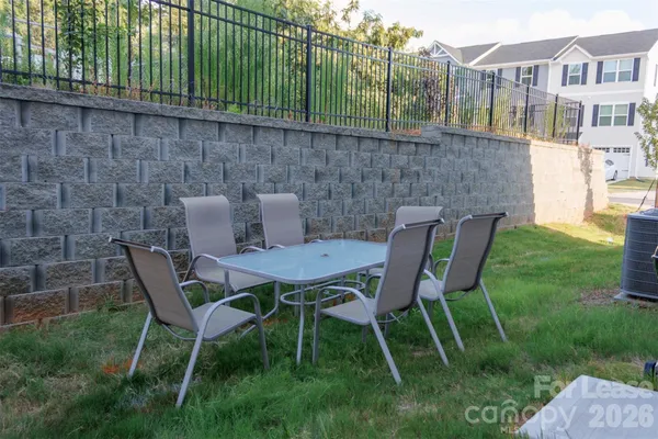 a view of a chairs and table in backyard