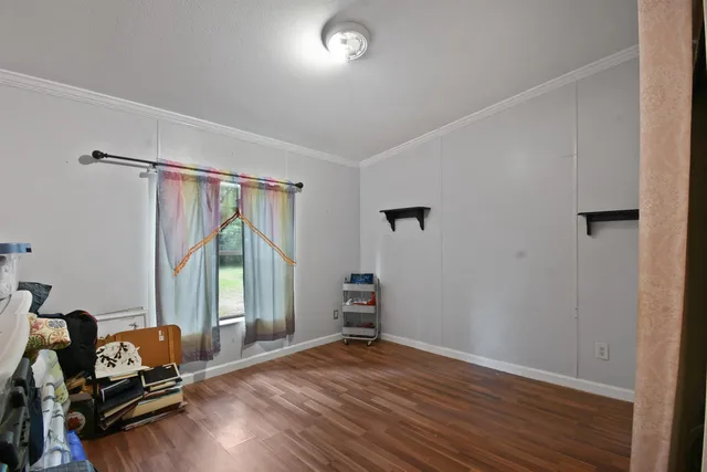a view of a room with wooden floor and furniture