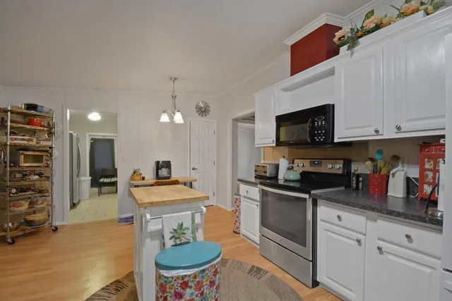 a kitchen with stainless steel appliances a stove a sink and a microwave