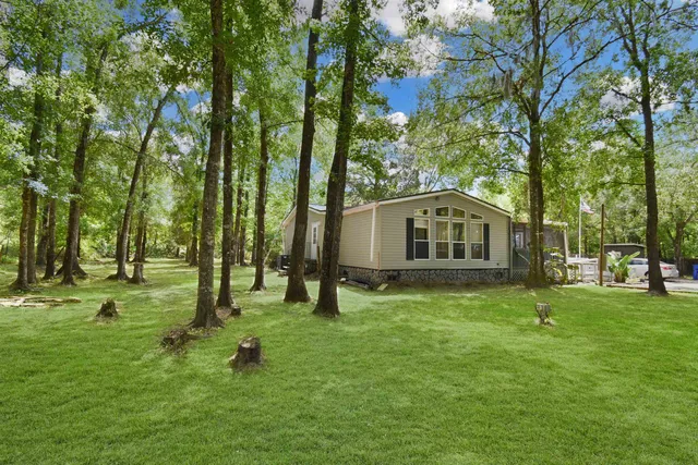 a view of a house with a backyard