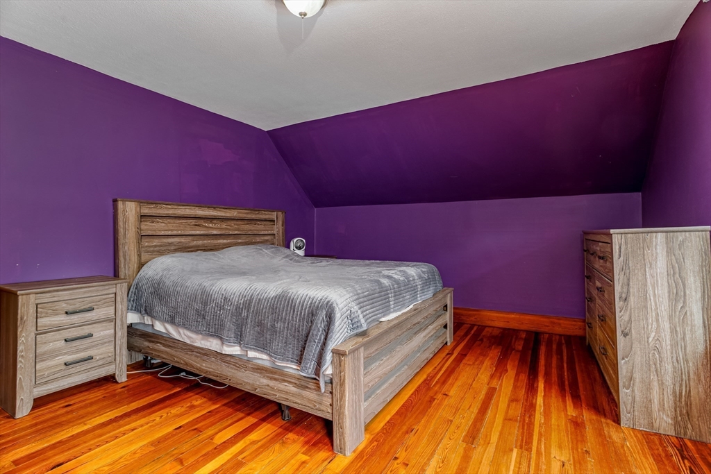 54 Charles Street Gardner, MA 01440 - Photo 22 of 40 a bedroom with a bed and wooden floor