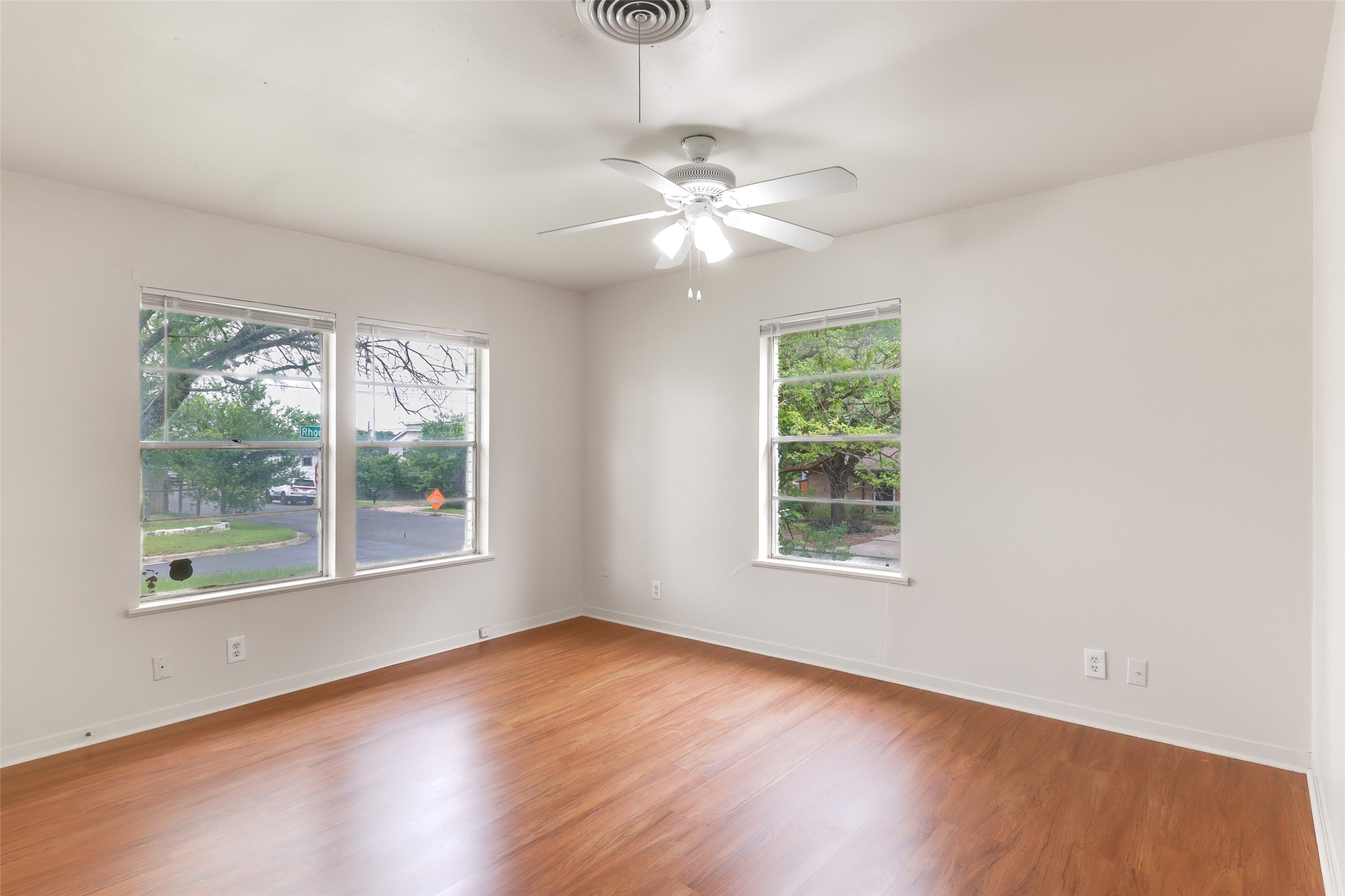 1800 Rhodes Road Austin, TX 78721 - Photo 11 of 14 a view of an empty room with wooden floor and a window