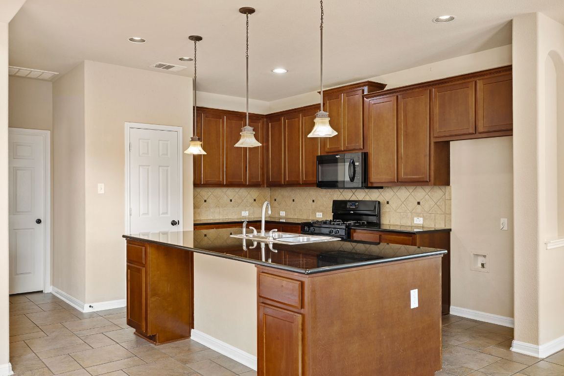676 Rusk Road Round Rock, TX 78665 - Photo 11 of 35 Kitchen with plenty of storage and counter space