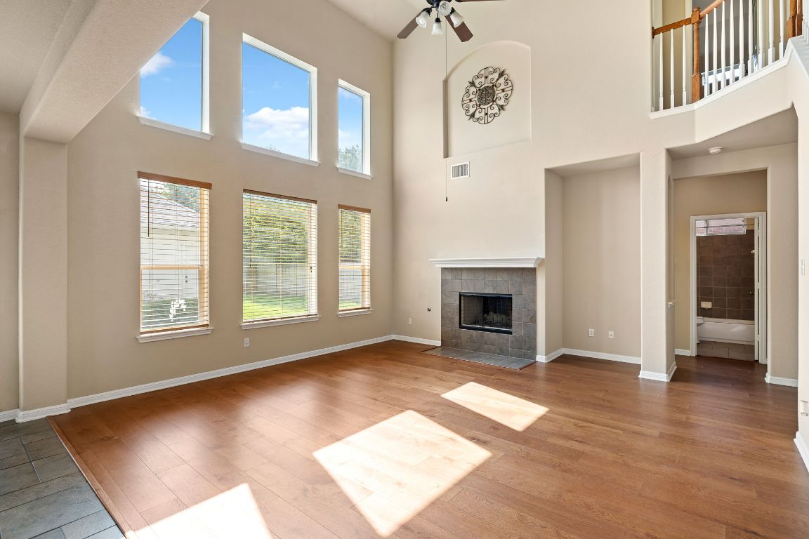 676 Rusk Road Round Rock, TX 78665 - Photo 8 of 35 Spacious living room featuring a gas fireplace