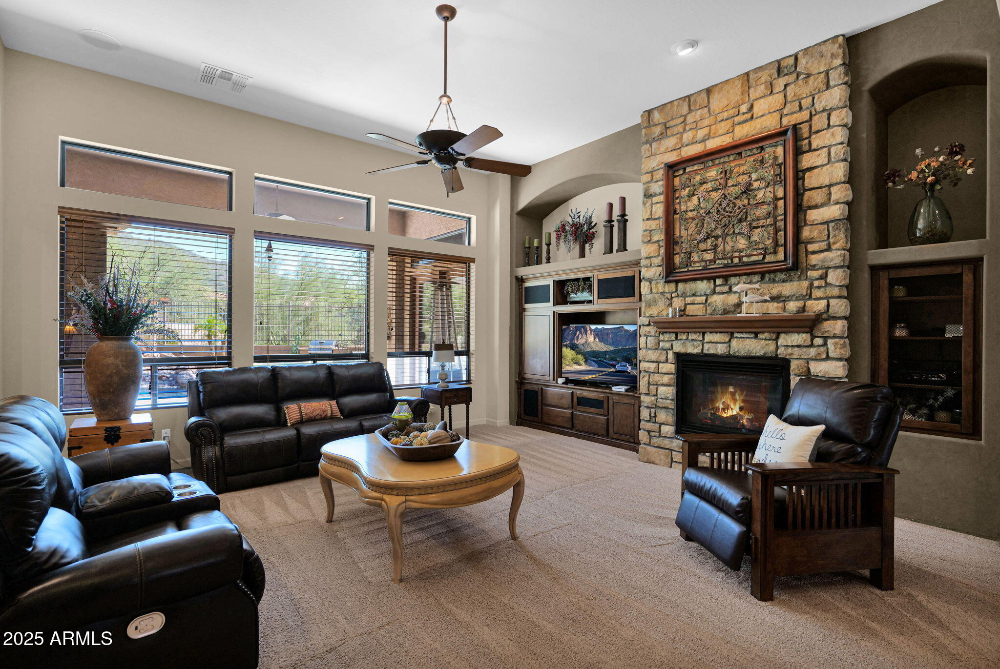 4207 North Arboles Circle Mesa, AZ 85207 - Photo 10 of 71 a living room with furniture a fireplace and a floor to ceiling window