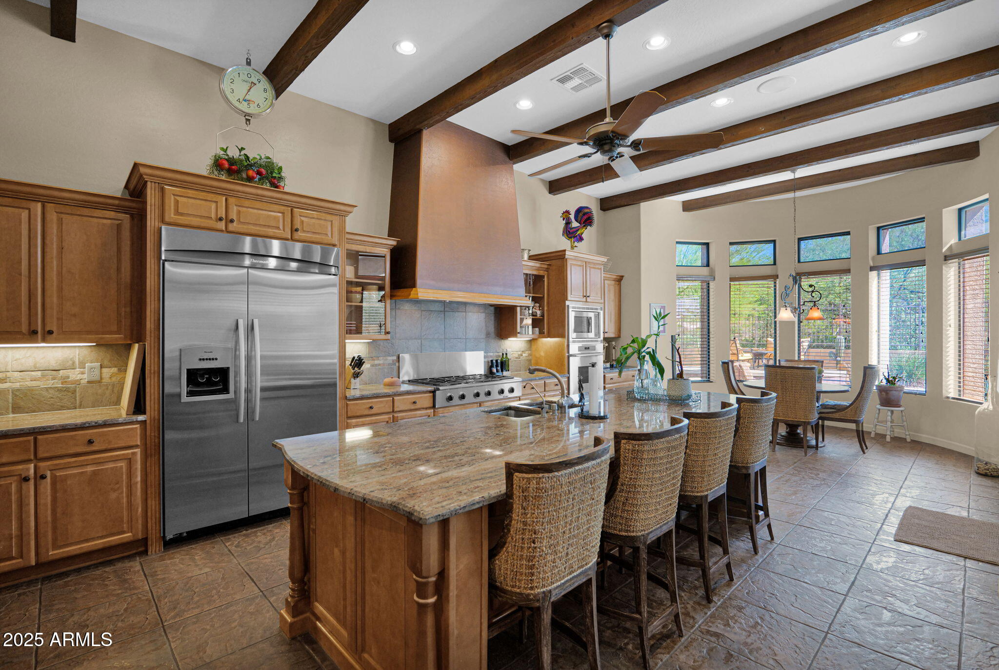 4207 North Arboles Circle Mesa, AZ 85207 - Photo 13 of 71 a kitchen with refrigerator cabinets dining table and chairs
