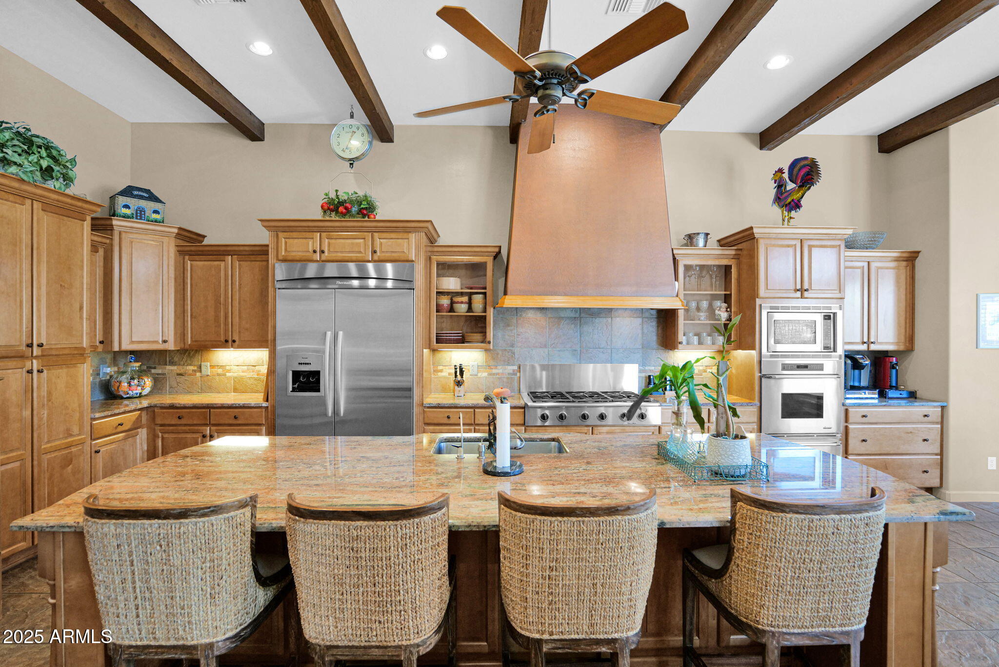 4207 North Arboles Circle Mesa, AZ 85207 - Photo 14 of 71 a kitchen with stainless steel appliances kitchen island granite countertop a table chairs in it and a wooden floors