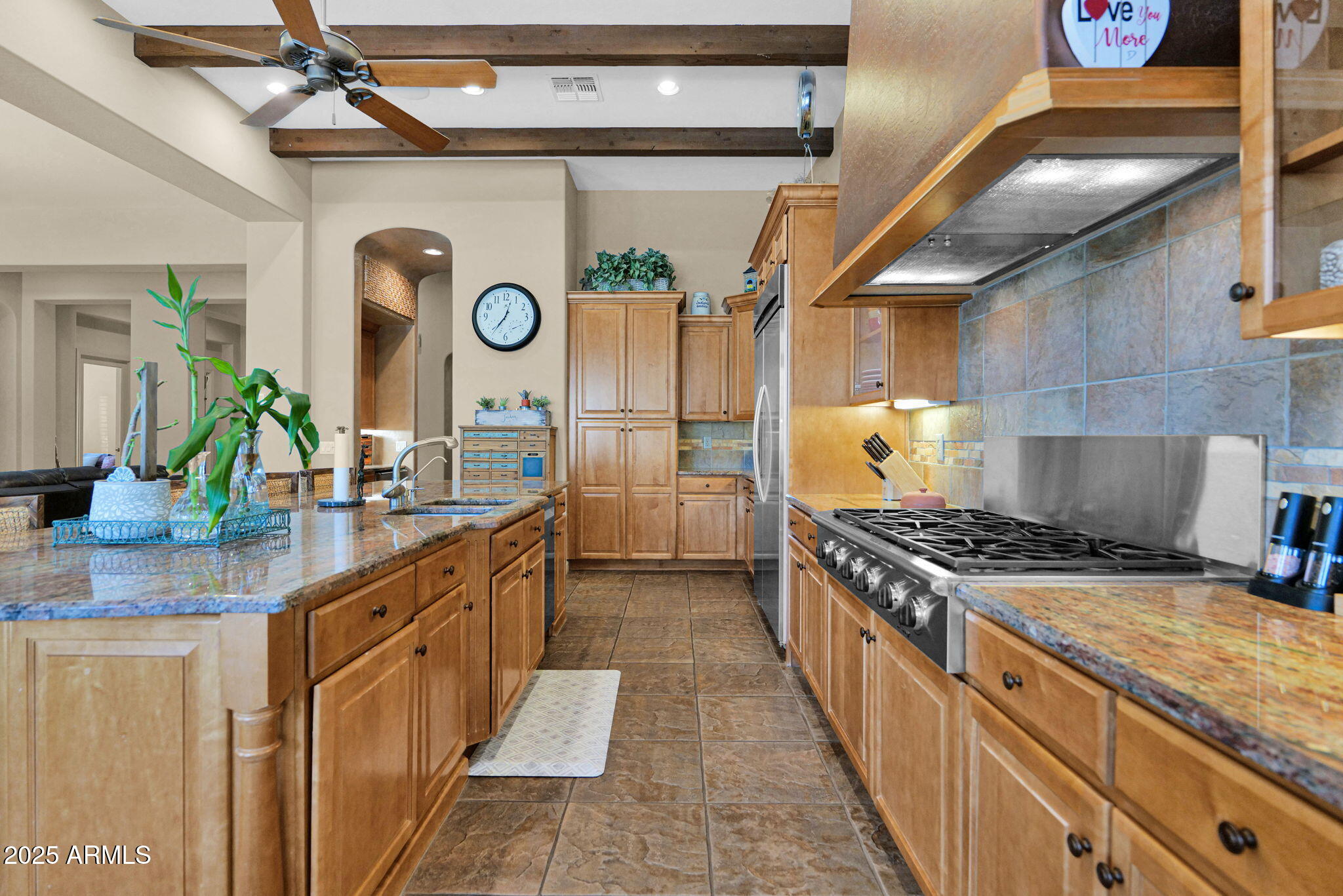 4207 North Arboles Circle Mesa, AZ 85207 - Photo 18 of 71 a kitchen with stainless steel appliances granite countertop a stove and a sink