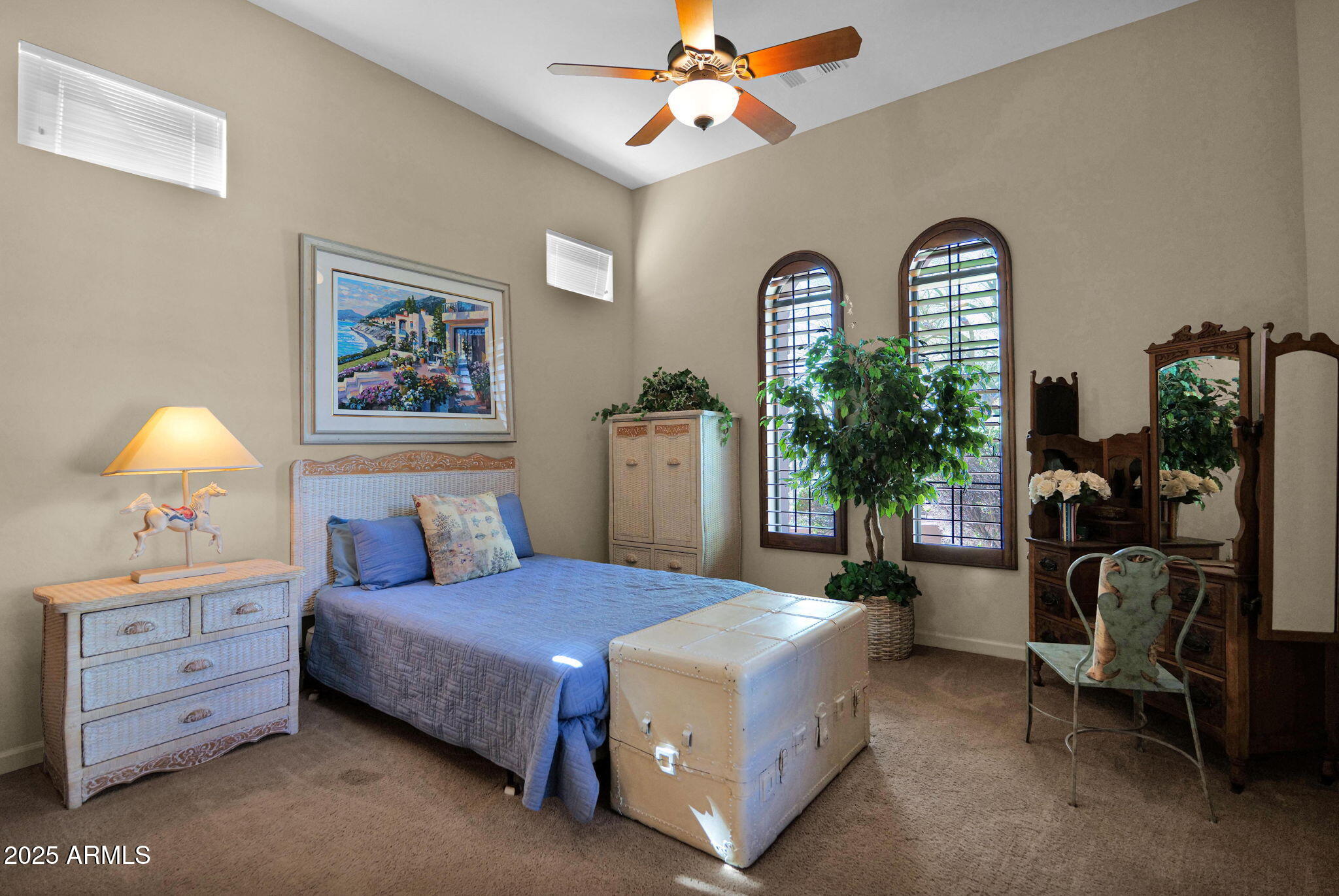 4207 North Arboles Circle Mesa, AZ 85207 - Photo 31 of 71 a bedroom with a bed and a chandelier