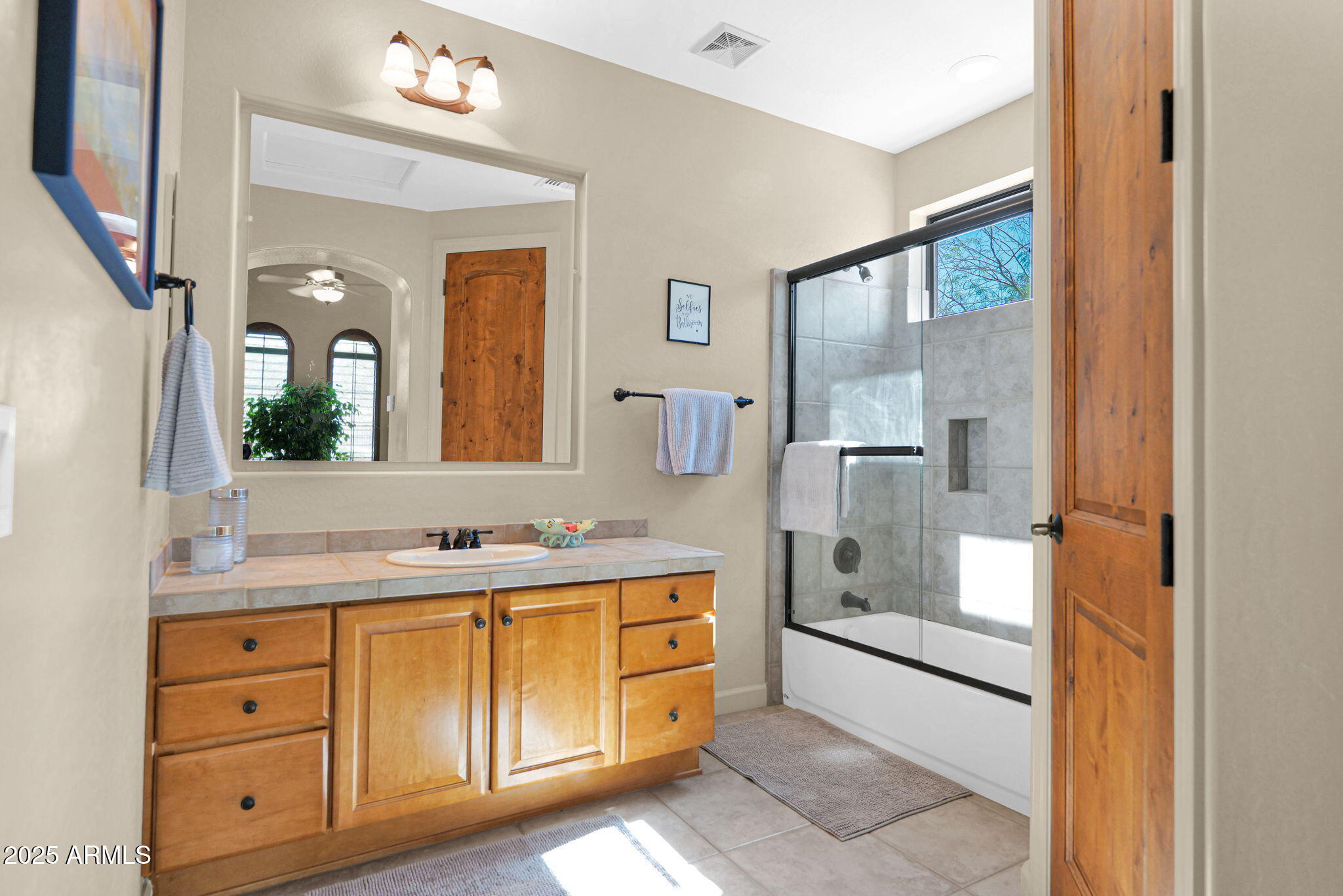 4207 North Arboles Circle Mesa, AZ 85207 - Photo 32 of 71 a bathroom with a double vanity sink mirror and shower