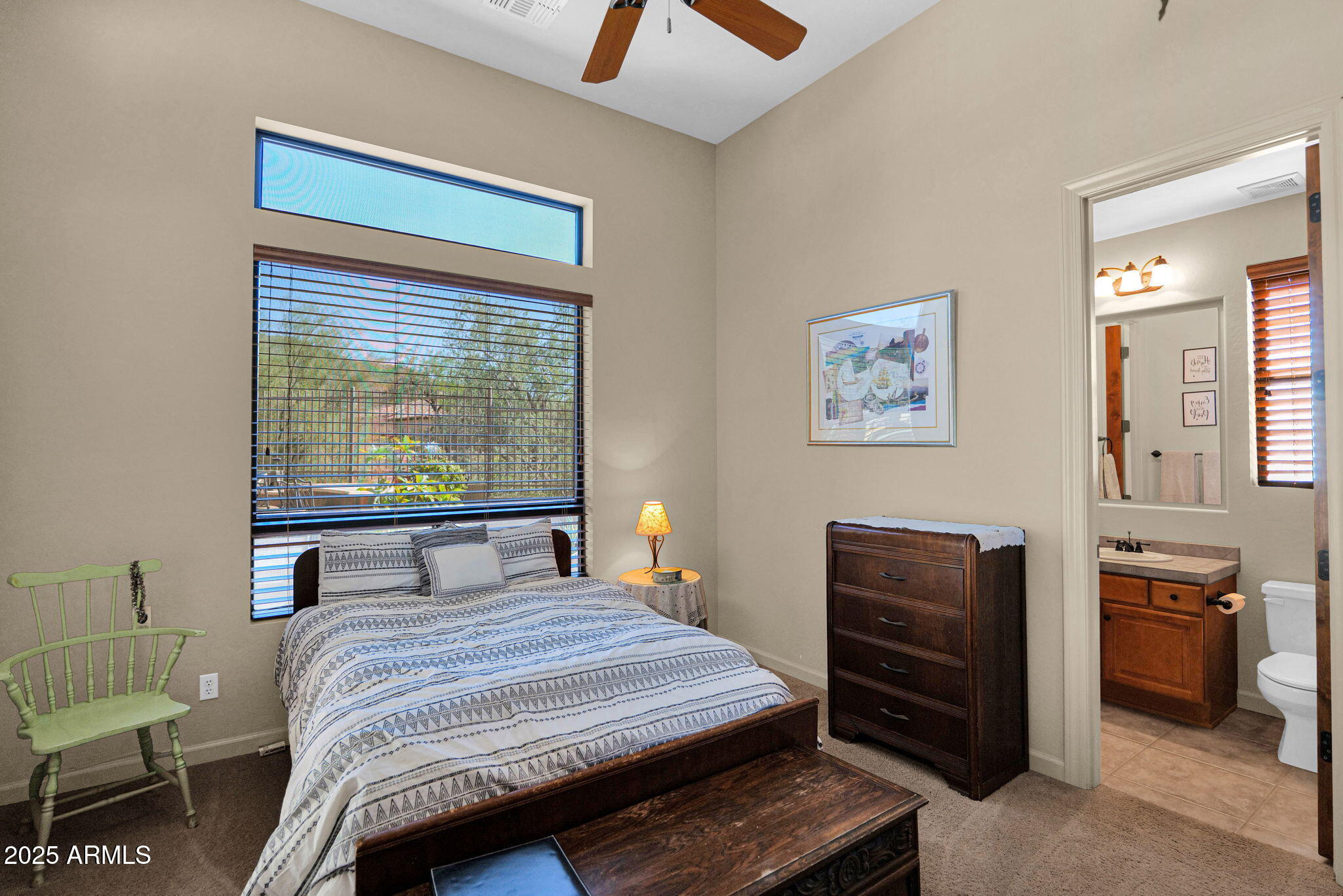 4207 North Arboles Circle Mesa, AZ 85207 - Photo 33 of 71 a bedroom with a bed and a chandelier