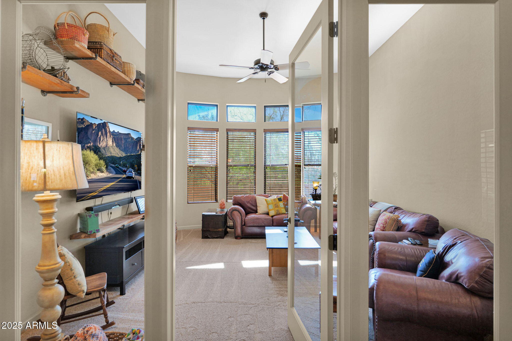 4207 North Arboles Circle Mesa, AZ 85207 - Photo 37 of 71 a living room with furniture cabinets and a flat screen tv