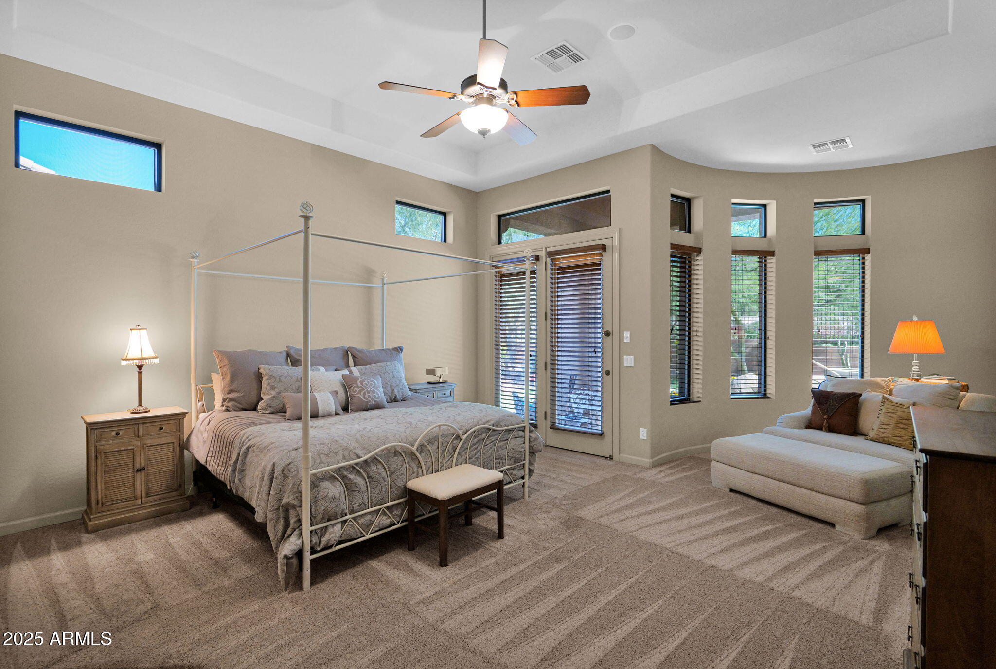 4207 North Arboles Circle Mesa, AZ 85207 - Photo 42 of 71 a bedroom with a large bed couch and a chandelier