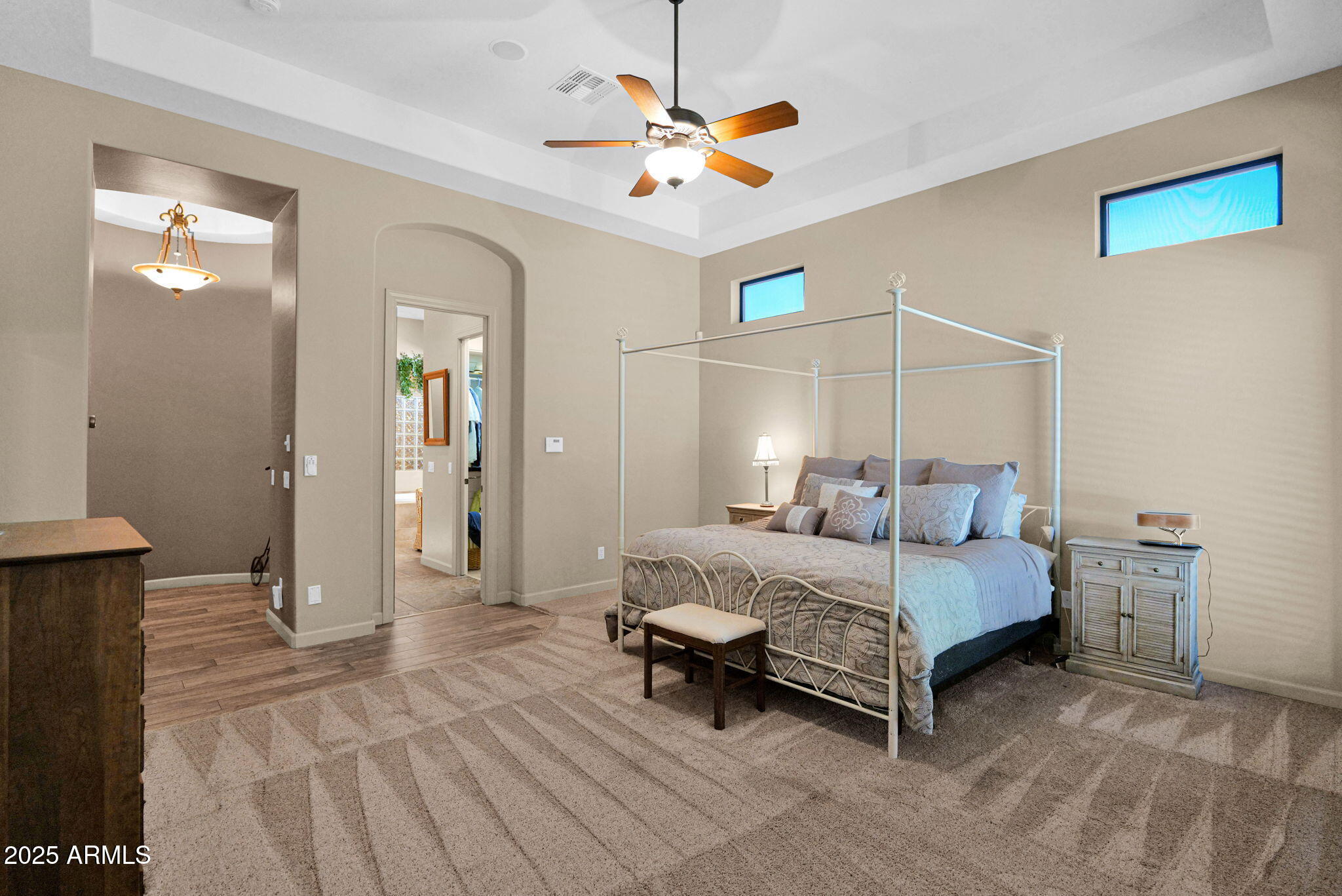 4207 North Arboles Circle Mesa, AZ 85207 - Photo 43 of 71 a bedroom with a bed and a chandelier