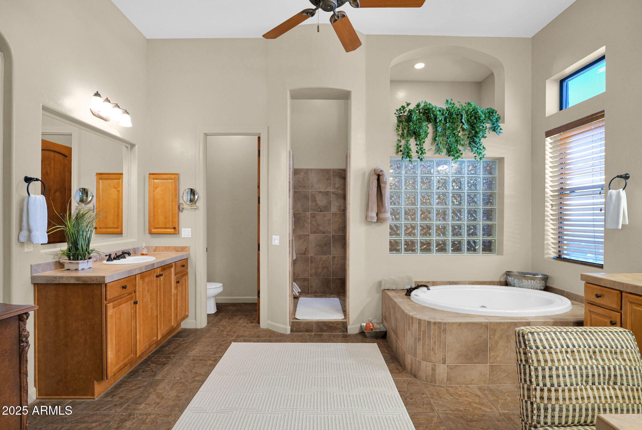 4207 North Arboles Circle Mesa, AZ 85207 - Photo 44 of 71 a bathroom with a tub sink and mirror