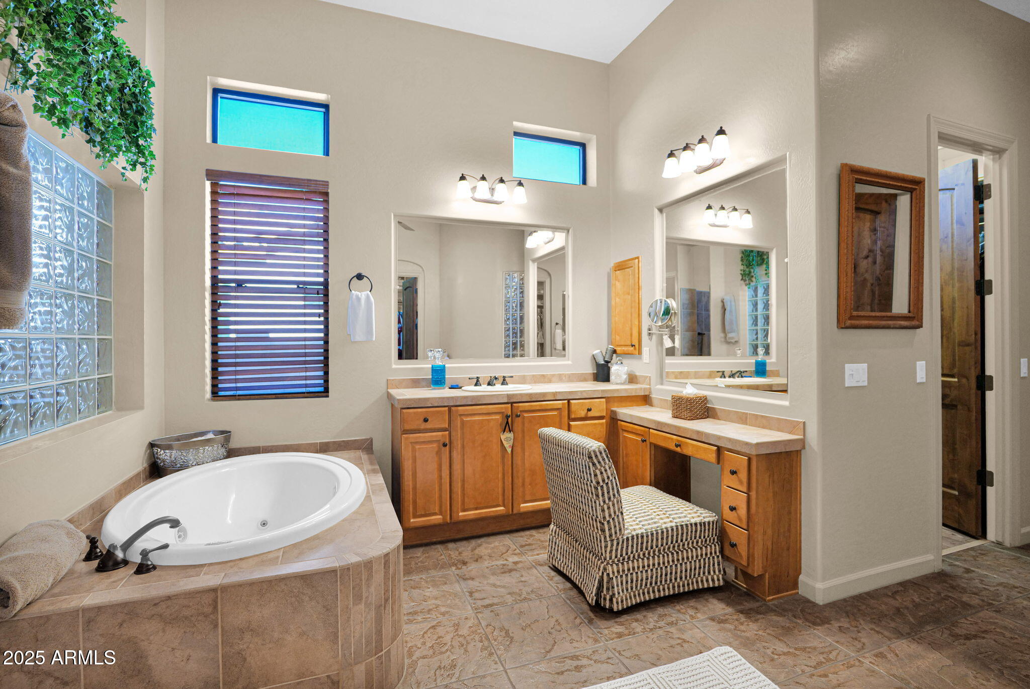 4207 North Arboles Circle Mesa, AZ 85207 - Photo 45 of 71 a bathroom with a granite countertop sink and a bathtub