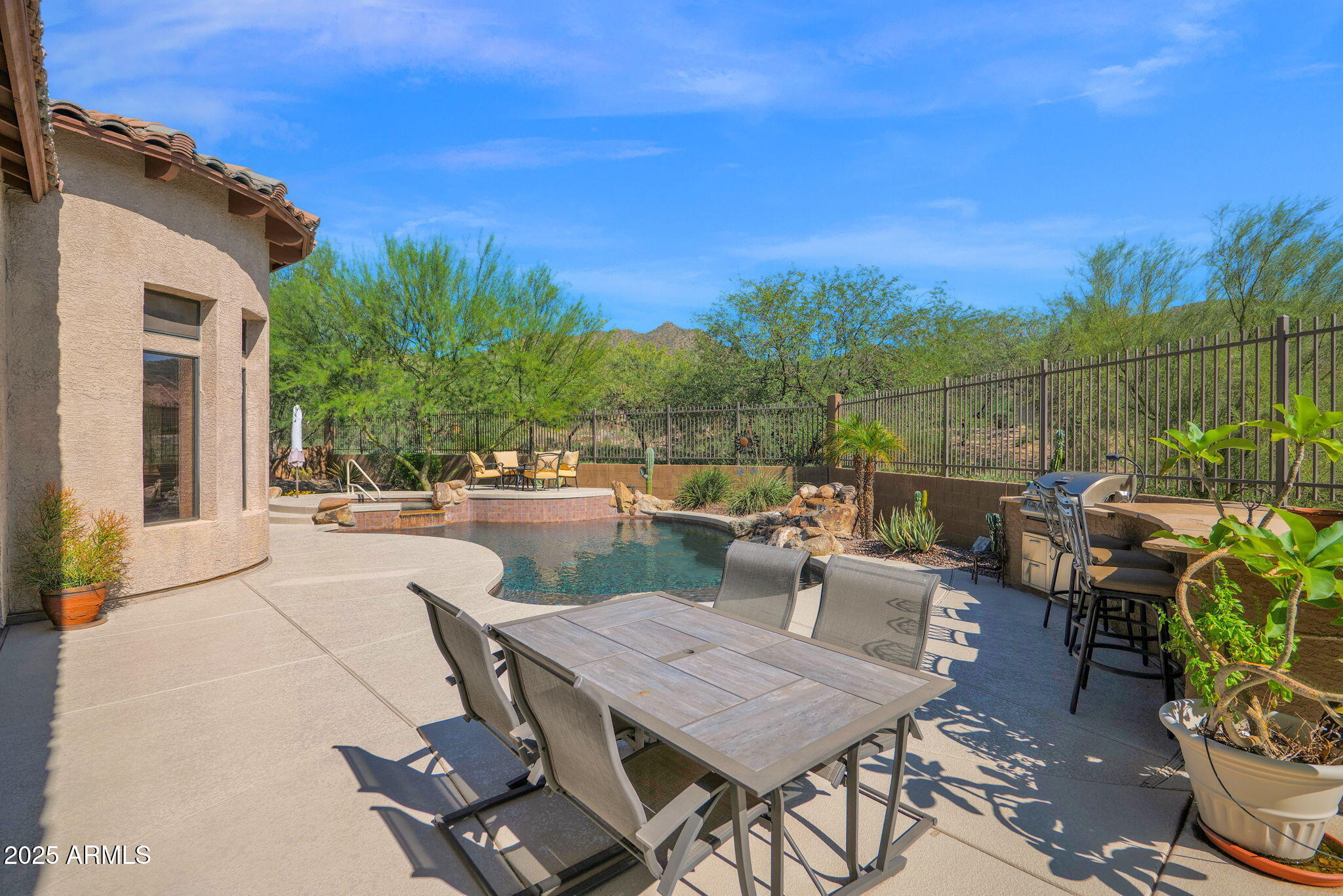 4207 North Arboles Circle Mesa, AZ 85207 - Photo 50 of 71 a view of a patio with couches table and chairs and potted plants