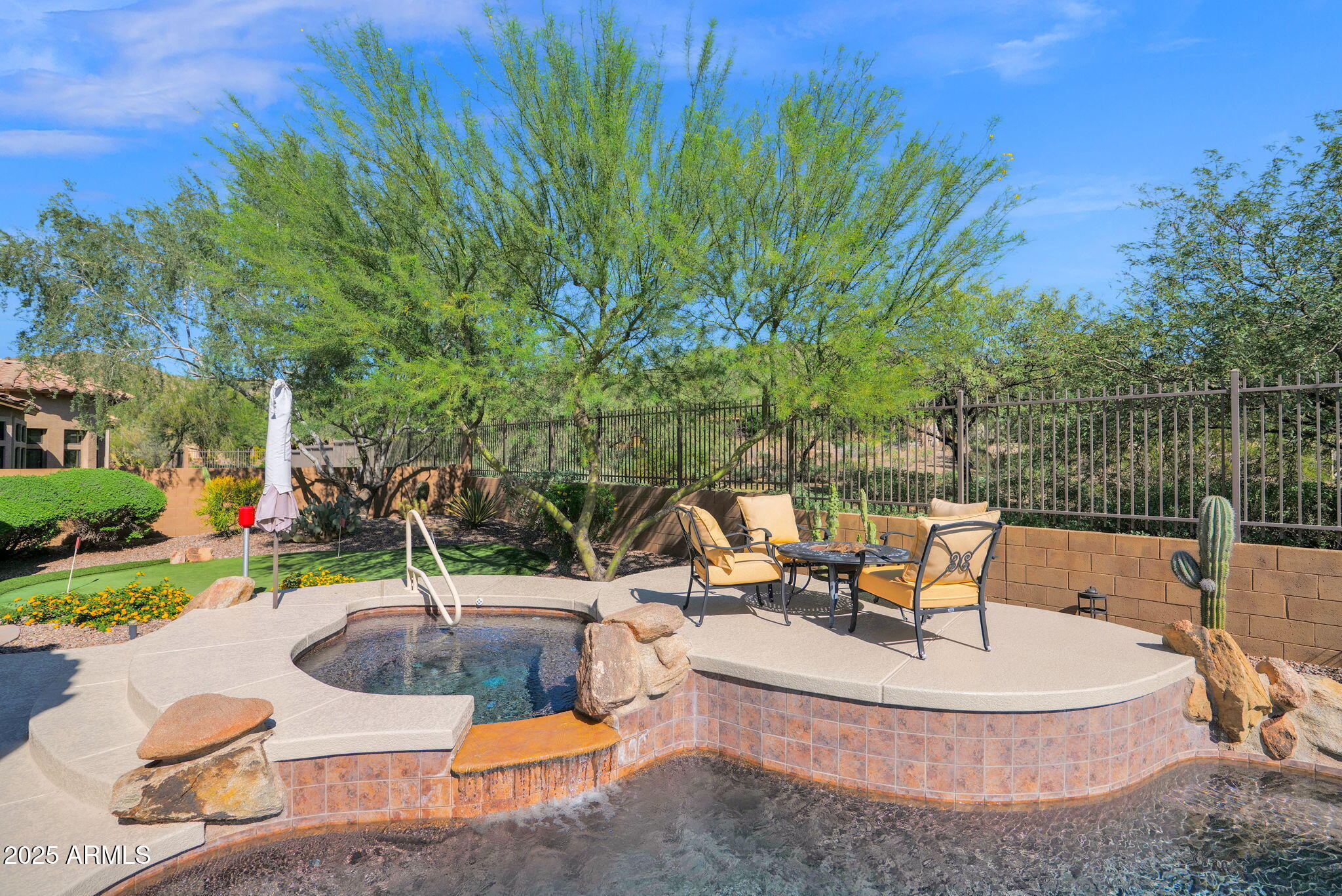 4207 North Arboles Circle Mesa, AZ 85207 - Photo 52 of 71 a view of a swimming pool with a sitting space