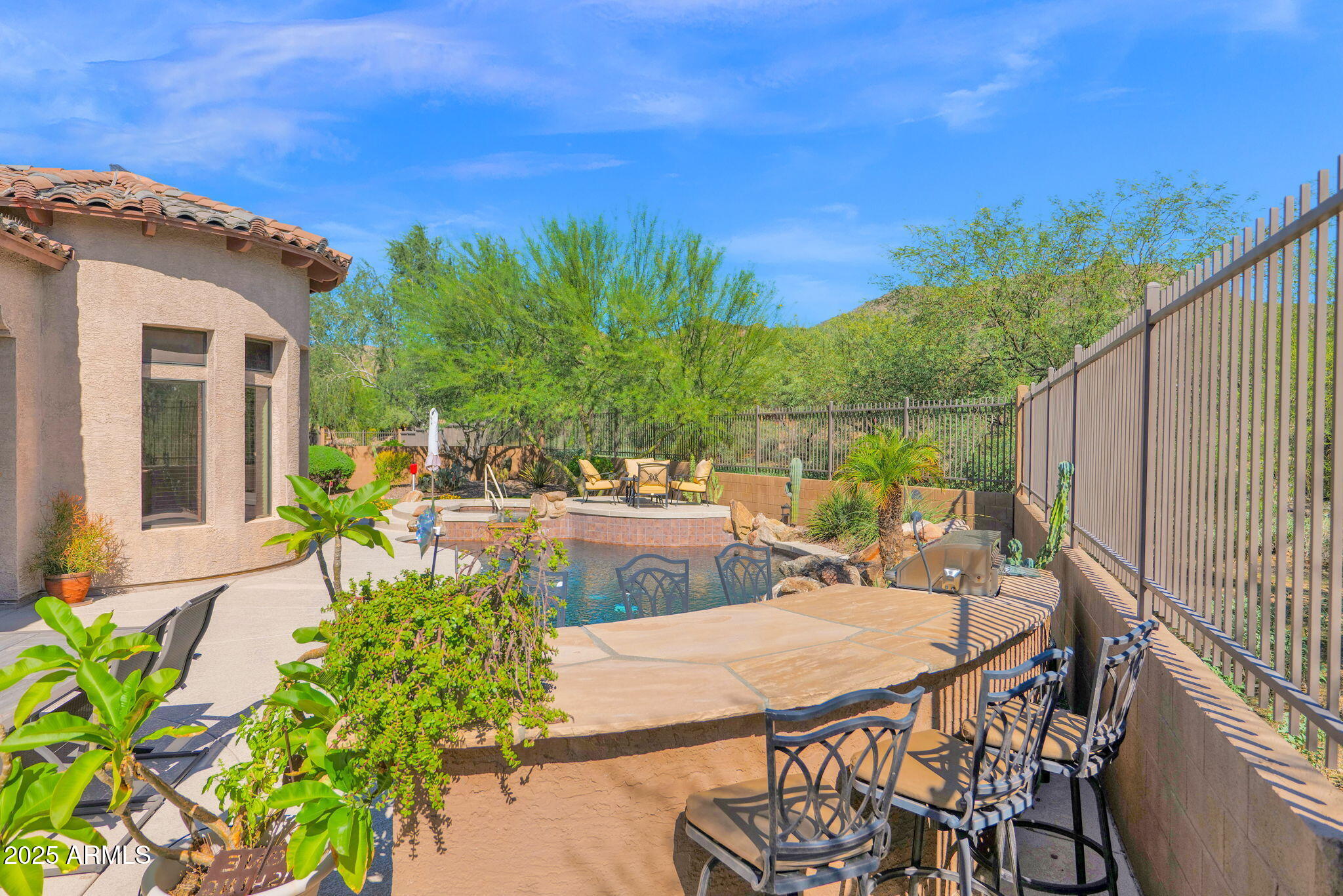 4207 North Arboles Circle Mesa, AZ 85207 - Photo 57 of 71 a view of a patio with table and chairs and potted plants