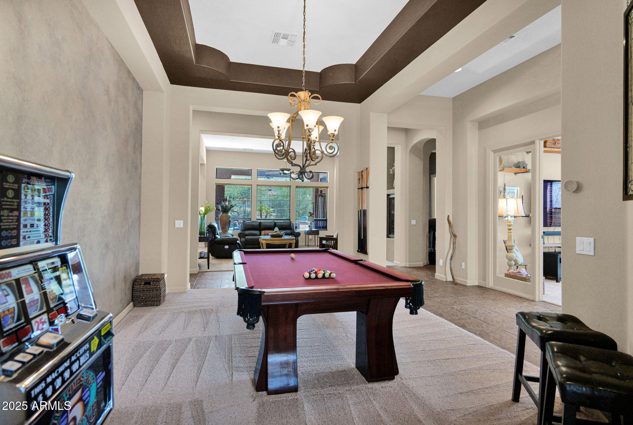 4207 North Arboles Circle Mesa, AZ 85207 - Photo 7 of 71 a living room with furniture a flat screen tv and a book shelf