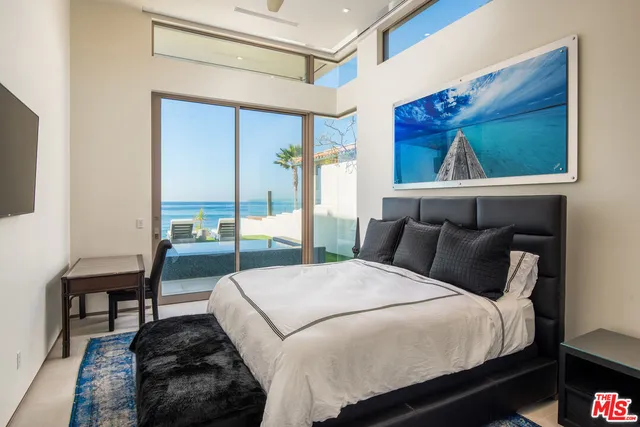 a bedroom with a bed and a ceiling fan