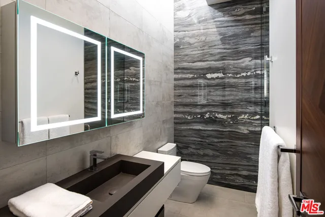 a bedroom with a bed and lamp with the dresser