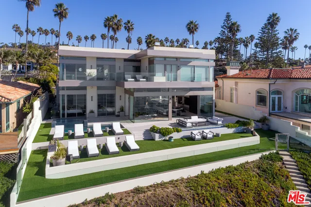 a front view of a house with a yard table and chairs